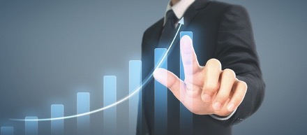 A guy in a suit touch a virtual graph in upwards growing position