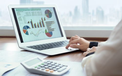 A laptop displaying graphs representing Accounting setups and systems