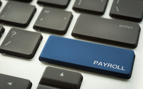Keyboard with a button labelled payroll in blue colour